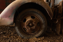 Tire of vintage truck in a barn