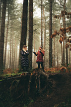 two women talking in a forest 