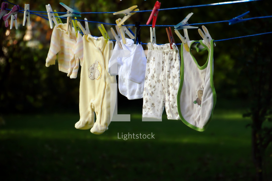 baby clothes drying at a laundry line. 
family, baby, clothes, washing, toddler, happy, dry, wet, drying, outdoor, hanging, hang, new, Christmas, born, newborn, little, small, child, children, kid, kids, playsuit, babygrow, rompers, romper suit, babywear, wear, wearing, baby clothes, baby garments, garments, clothesline, line, clothes line, laundry, laundry line, washing line, dry off, air, offspring, junior, generation, grow, growing, growth, descendants, descendant, increase, increasing, fruitful, birth 