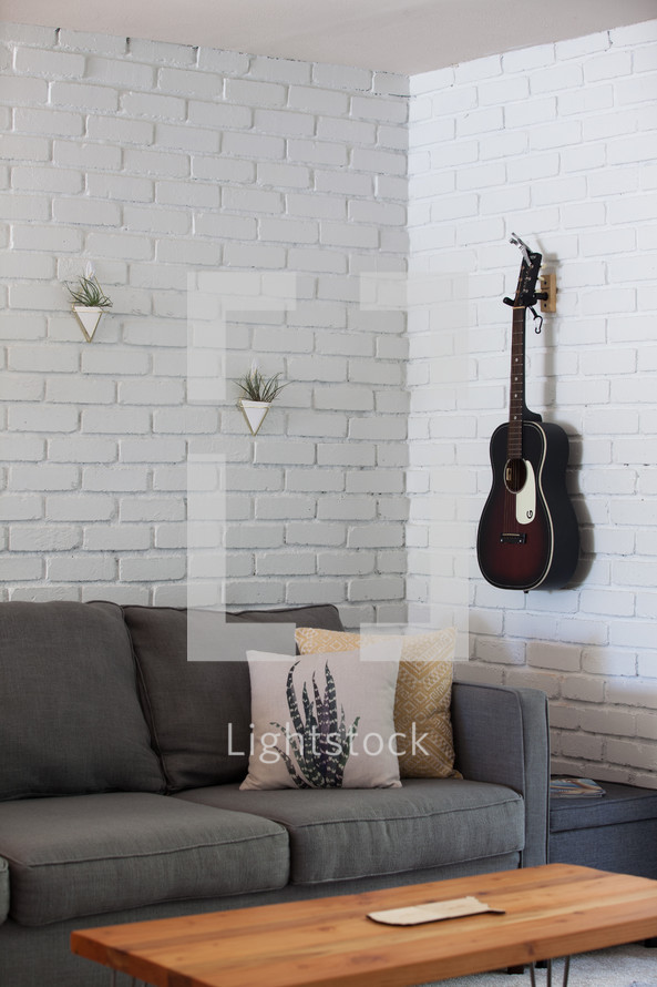 guitar on a wall in a living room 