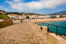 stone walkway beside a beach in Spain 