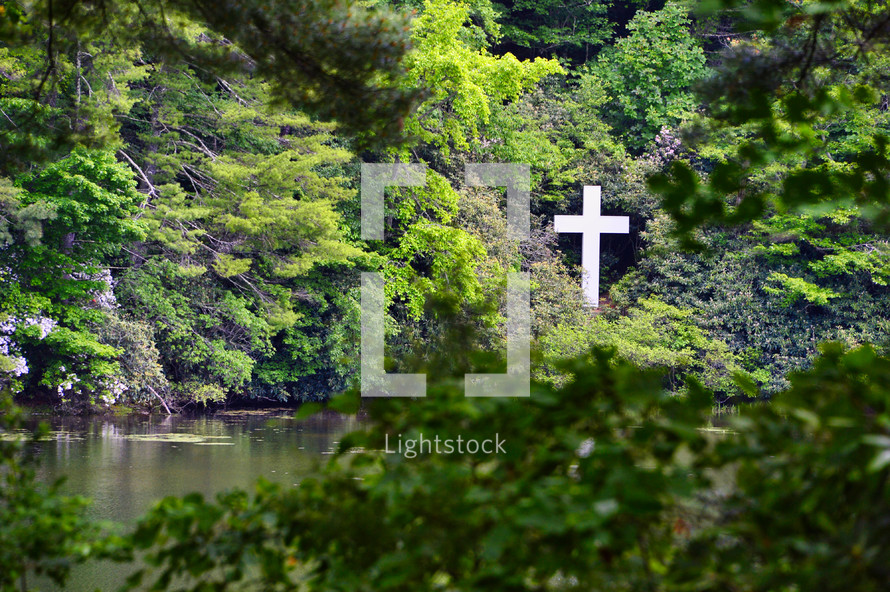 white cross by a lake 