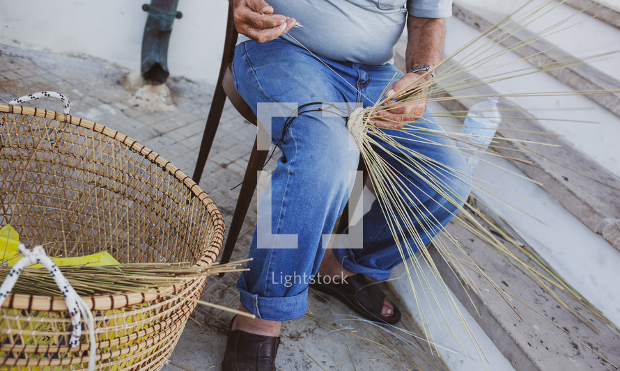 Elderly man makes baskets for use in the fishing industry in the traditional way, Puglia in Italy.
