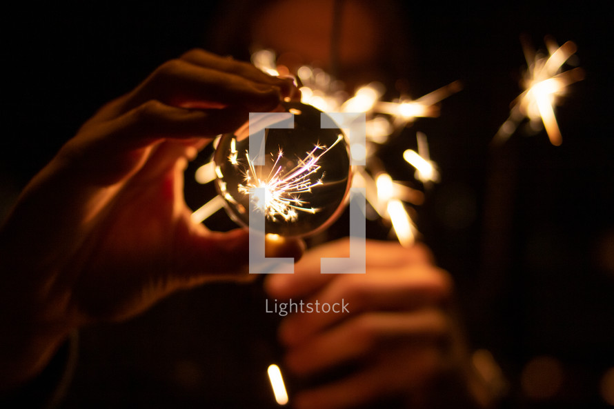 sparks from a sparkler and glass orb