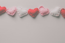 stitched felt hearts on a white background 