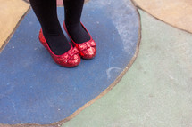 Woman with red glittered shoes and black stockings