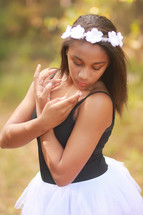 a teen girl in a tutu prating ballet 