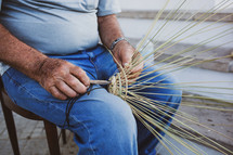 Elderly man makes baskets for use in the fishing industry in the traditional way, Puglia in Italy.