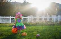 girl in a costume trick or treating 
