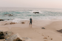 a man standing on a beach 