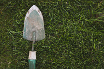 a shovel in the grass