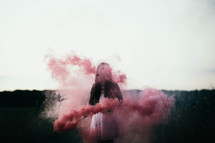 a woman with a smoke flare 