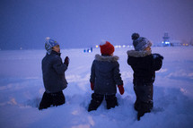 kids playing in snow at night 