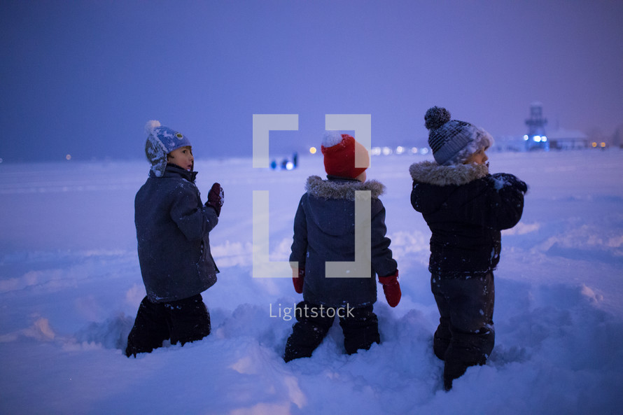 kids playing in snow at night 