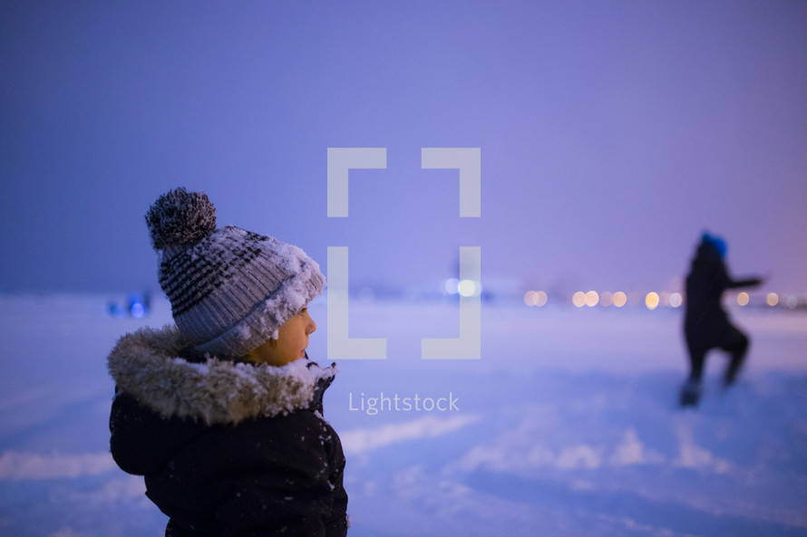kids playing in snow in winter at night 