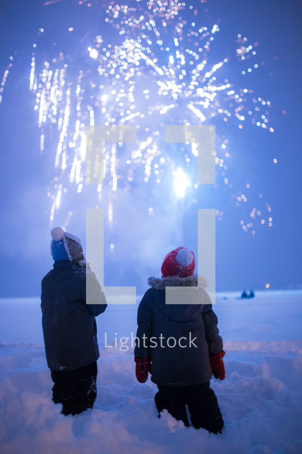 kids watching fireworks in snow 