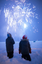 kids watching fireworks in snow 