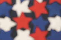 blurred felt stars in red, white, and blue 