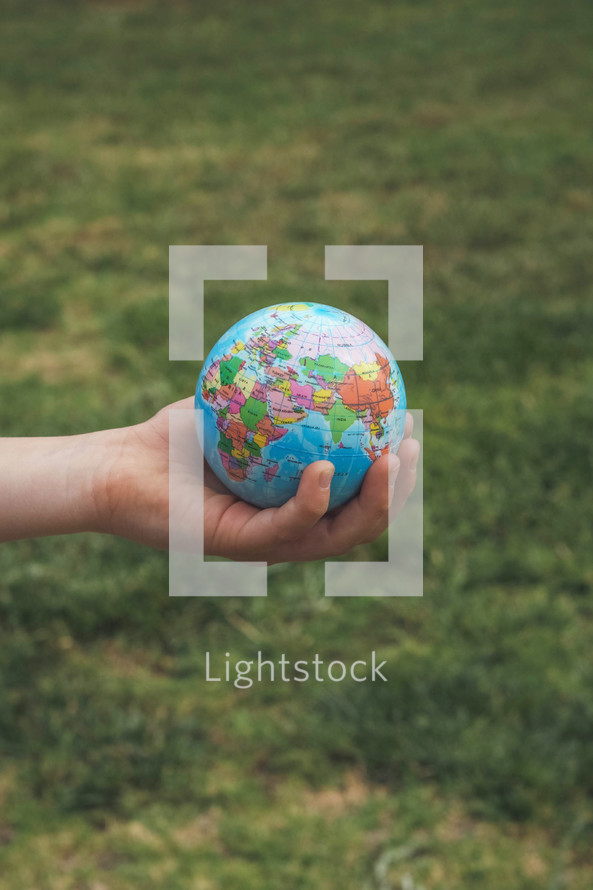 hand holding a globe 