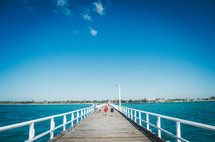 A jetty on the bay with a clear blue sky.