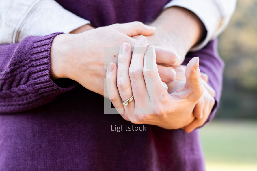 couple hugging and holding hands 