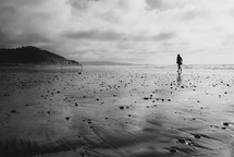 silhouette of a woman walking on a  beach 