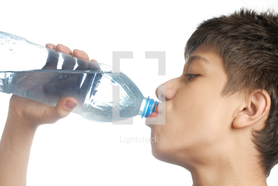 a boy drinking bottled water 