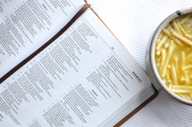Bible opened to Psalms and bowl of soup 