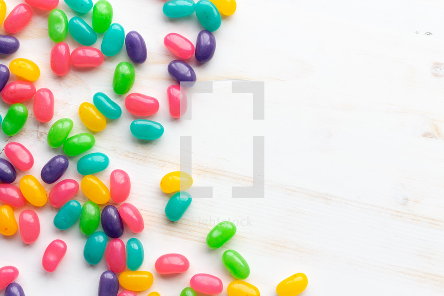 jelly beans on a white wood background 