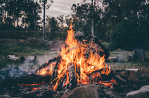a campfire burning at dusk