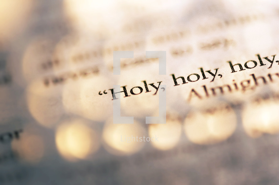 A macro shot of the words "Holy, holy, holy", in colour.