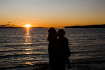 silhouette of mother and son at sunset 