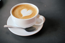 mug of coffee with heart shaped creamer 