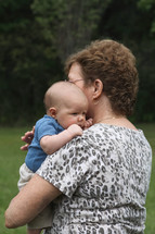 grandmother holding a newborn grandson 
