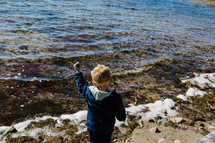 a child skipping rocks 