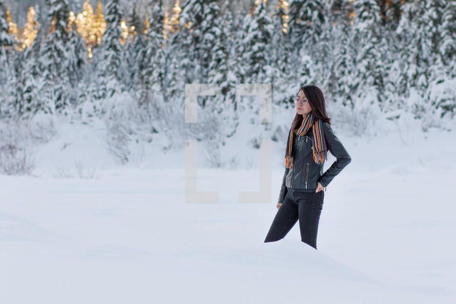 a woman standing in deep snow 
