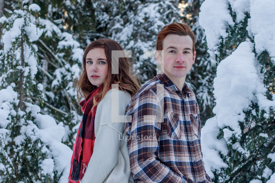 young couple standing outdoors in snow 