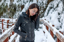 a young woman standing outdoors in snow 