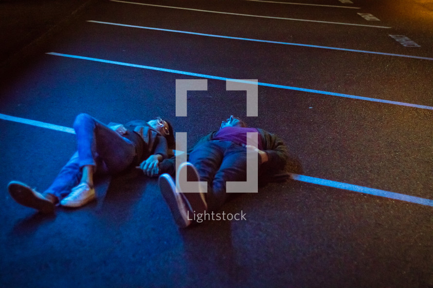couple lying in a parking space 