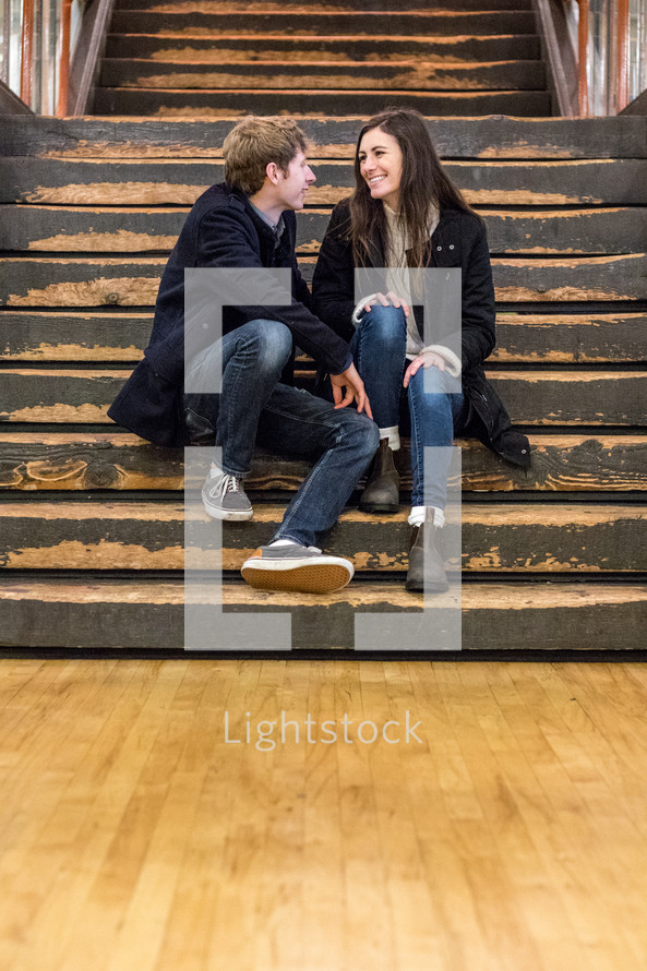 a couple sitting in a stairwell 