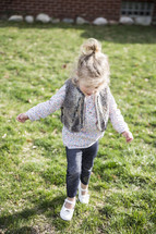 a girl running in the grass