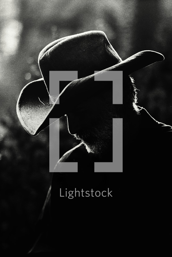 Silhouette of a man in a cowboy hat.