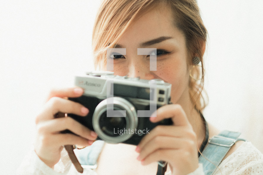 young woman holding a camera 