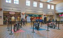 motorcycles on display in a food court 