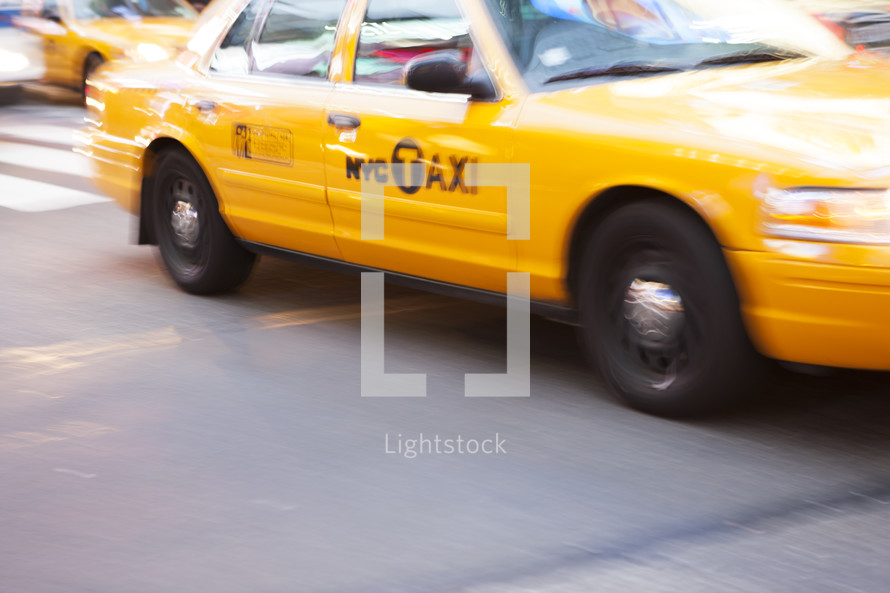 Yellow Taxi Cab in in motion, New York City, New York, USA. - for editorial use only.