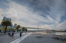 San Francisco Bay Bridge, palm trees, street lamps, runners, jogging, picnic benches 