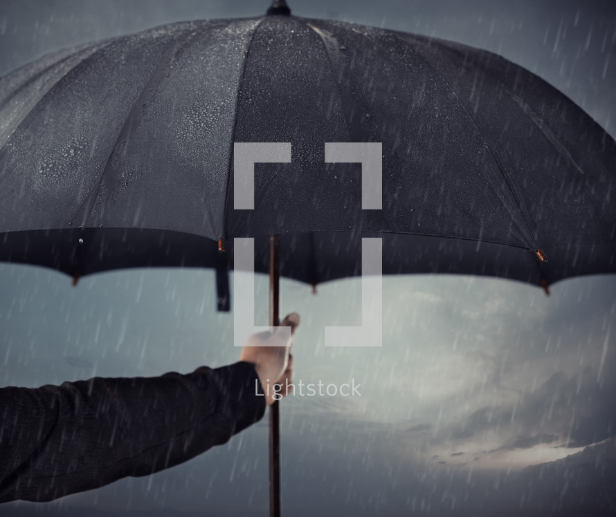 a man holding an umbrella in the rain 