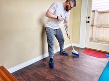 a man sweeping the floor 