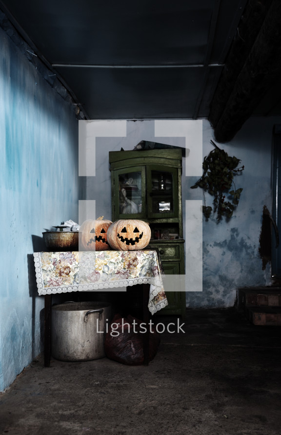 jack-o'-lanterns in a dark room 