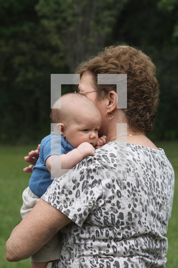 grandmother holding a newborn grandson 